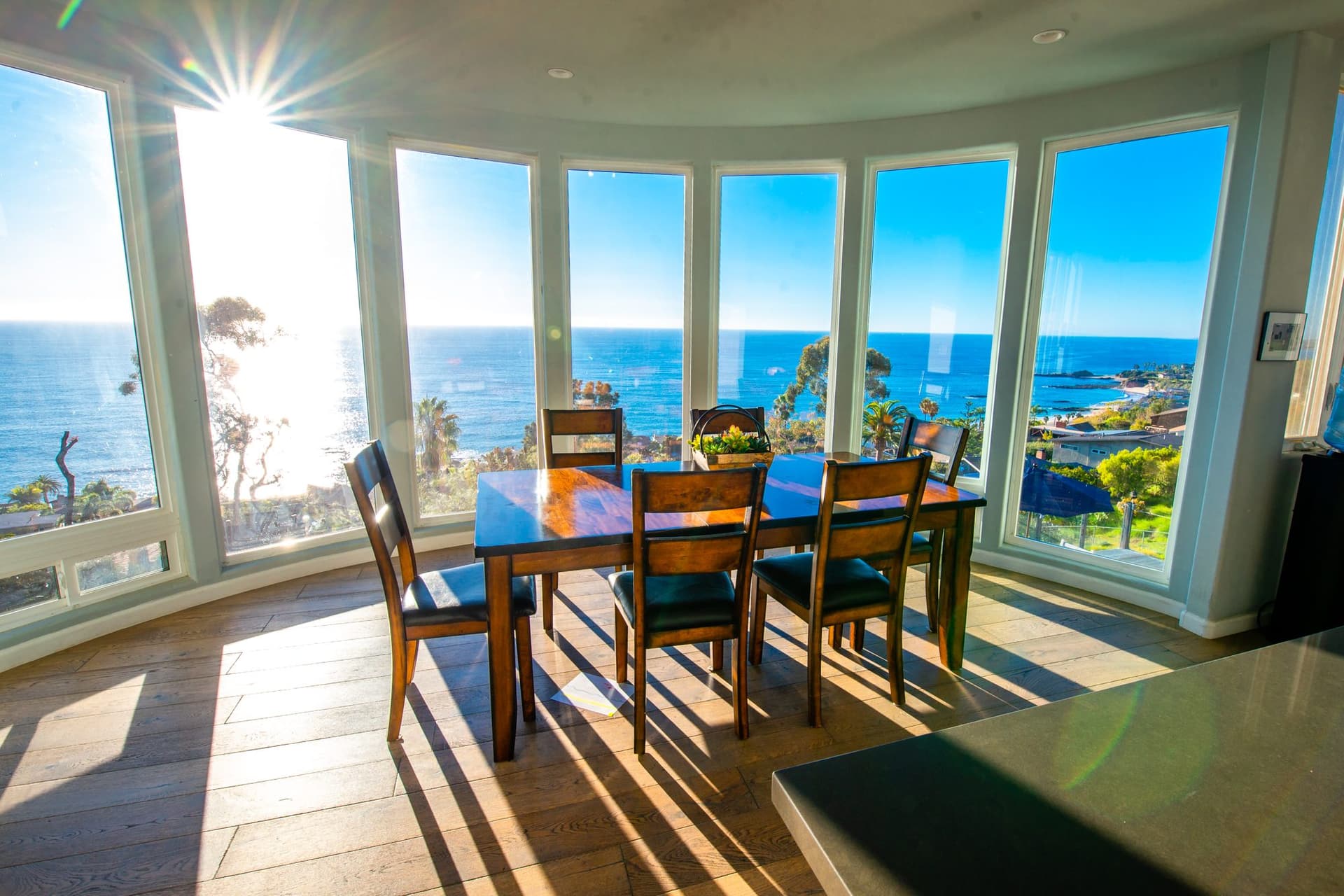 Dining room at Laguna View Detox wrapped in floor-to-ceiling windows overlooking the Pacific